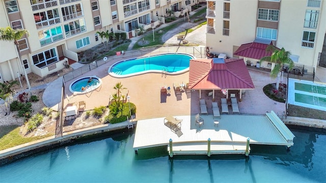 community pool with a boat dock