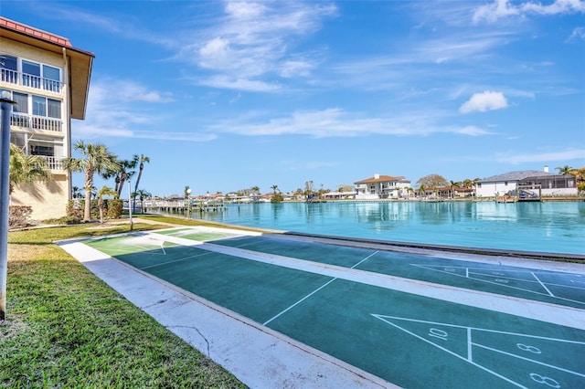 surrounding community featuring shuffleboard and a water view