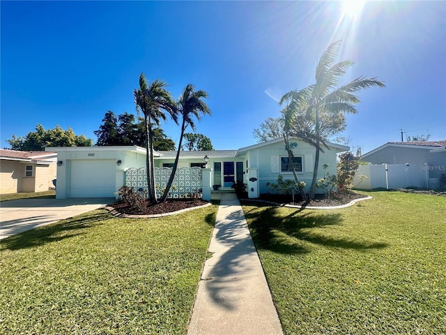 view of front of property featuring stucco siding, concrete driveway, fence, a garage, and a front lawn