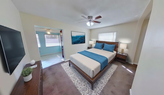 carpeted bedroom with baseboards and a ceiling fan