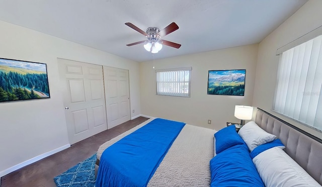 bedroom featuring ceiling fan, a closet, and baseboards