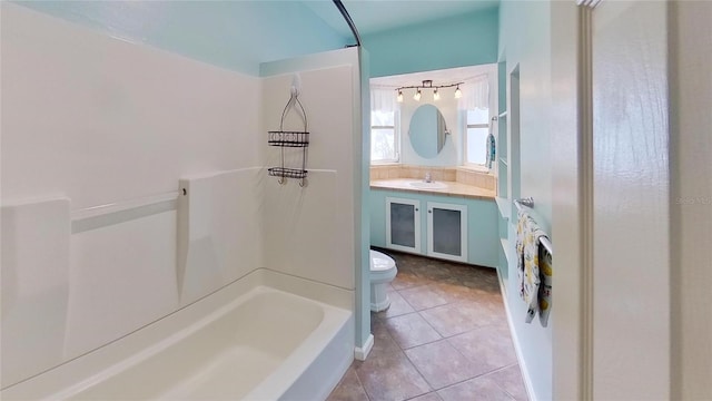 full bath featuring toilet, tile patterned floors, tub / shower combination, and vanity