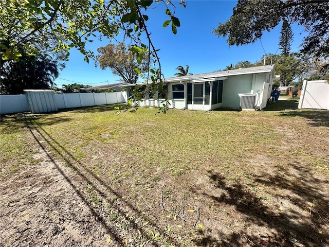 view of yard with fence and a sunroom