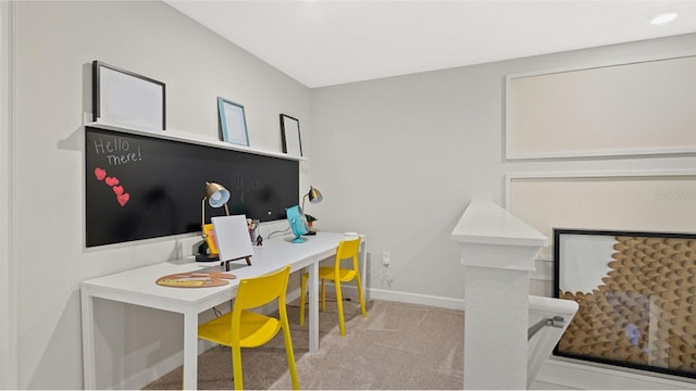 carpeted office featuring baseboards