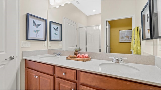 full bathroom featuring a stall shower, visible vents, a sink, and double vanity