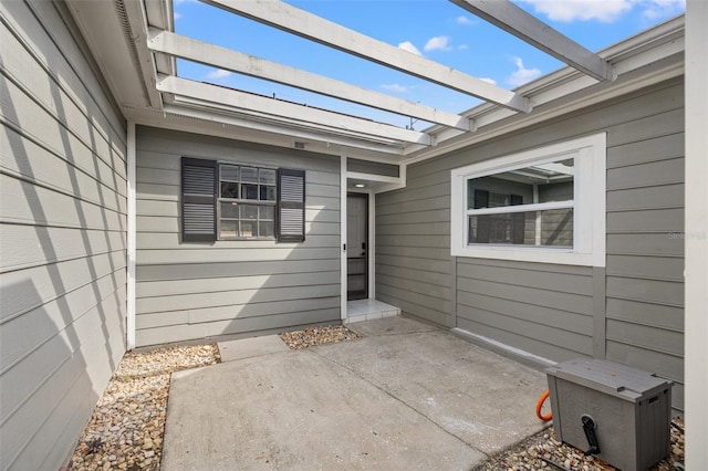 property entrance featuring a patio area