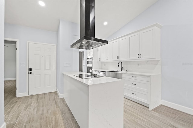 kitchen featuring a sink, light countertops, light wood-style floors, black electric stovetop, and island range hood