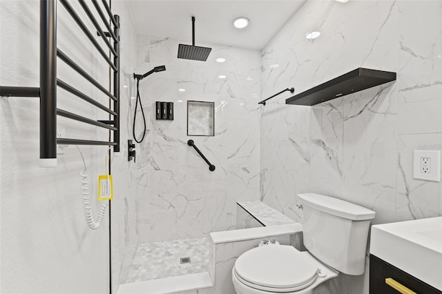 bathroom featuring a marble finish shower, toilet, and vanity