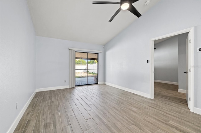 empty room with ceiling fan, baseboards, high vaulted ceiling, and wood finished floors