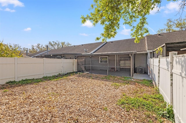 back of house with a patio area, central AC unit, a fenced backyard, and a sunroom