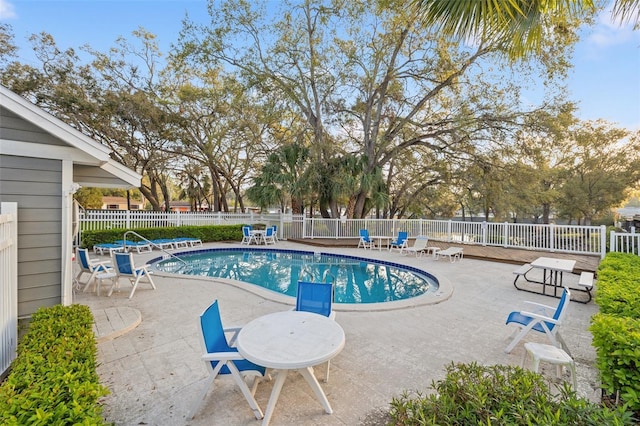 community pool featuring a patio area and fence