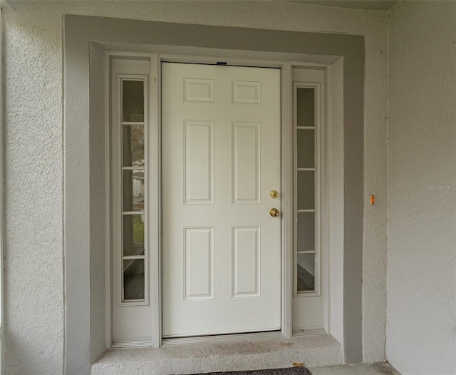 property entrance featuring stucco siding