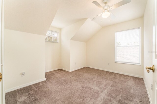 additional living space featuring a ceiling fan, carpet flooring, vaulted ceiling, and baseboards