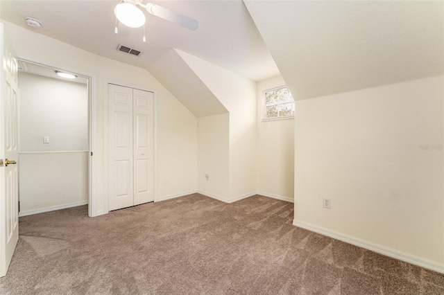 bonus room with lofted ceiling, carpet flooring, visible vents, and baseboards