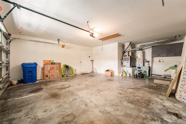 garage with water heater and a garage door opener