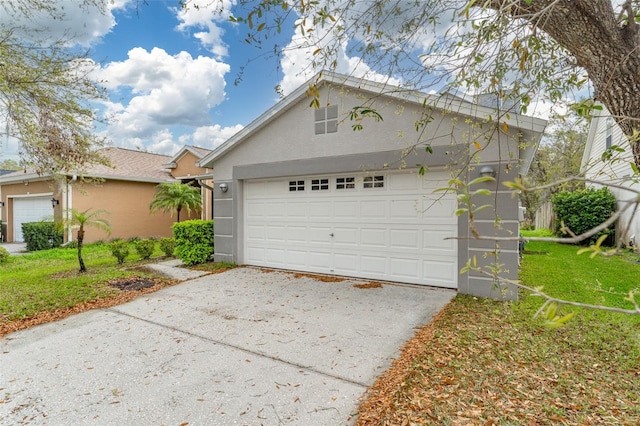 view of front of property with driveway, an attached garage, and stucco siding