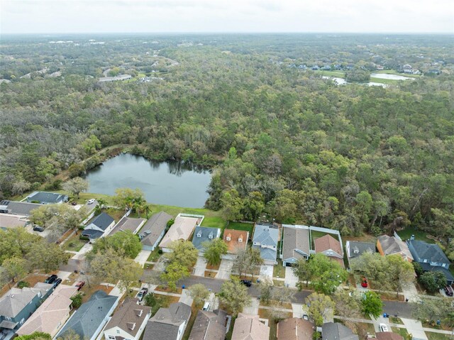 bird's eye view featuring a residential view, a water view, and a wooded view