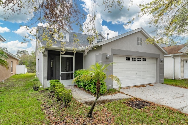 view of front of property with an attached garage, a sunroom, concrete driveway, roof with shingles, and stucco siding