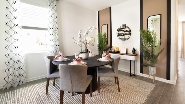 dining room with wood tiled floor and baseboards