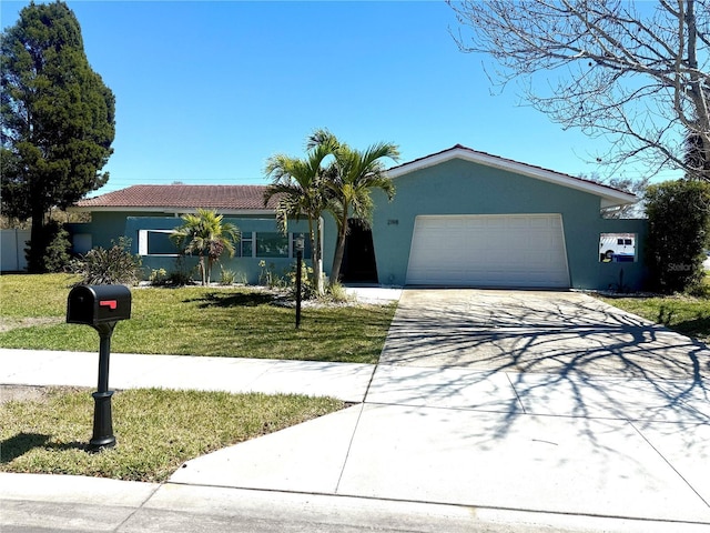 single story home with a tile roof, stucco siding, concrete driveway, a front yard, and a garage