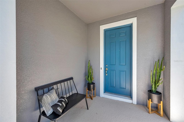 entrance to property featuring stucco siding