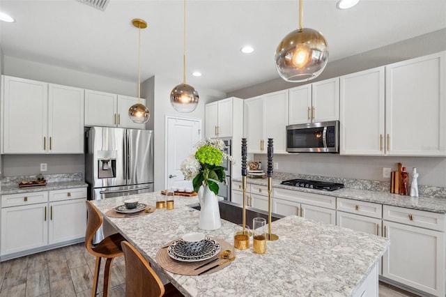 kitchen featuring appliances with stainless steel finishes and white cabinetry