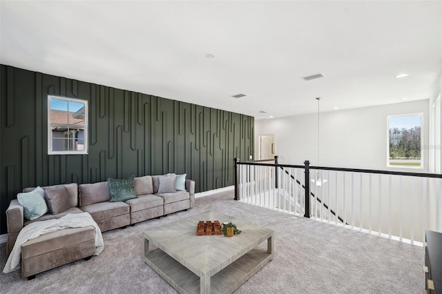 living area featuring carpet floors, recessed lighting, visible vents, and baseboards