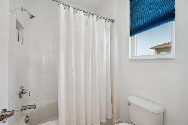 bathroom featuring shower / bath combo and toilet