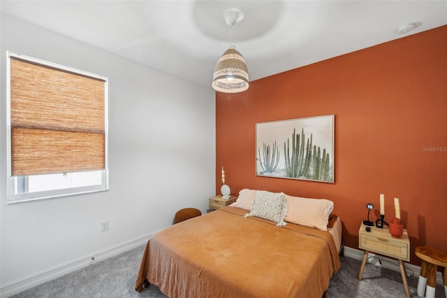 carpeted bedroom featuring baseboards