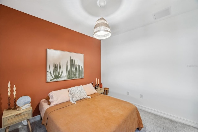 carpeted bedroom with baseboards and visible vents