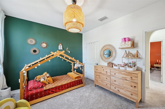 carpeted bedroom featuring visible vents