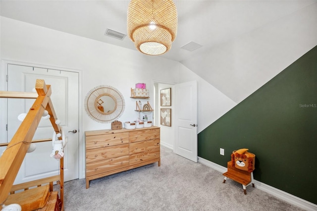 carpeted bedroom with vaulted ceiling, visible vents, and baseboards