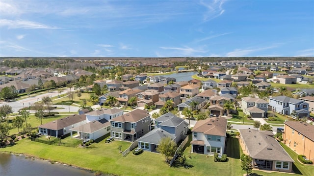 birds eye view of property with a residential view and a water view