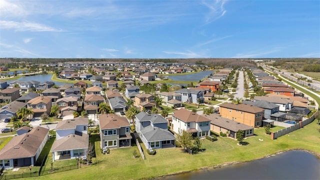 drone / aerial view featuring a water view and a residential view