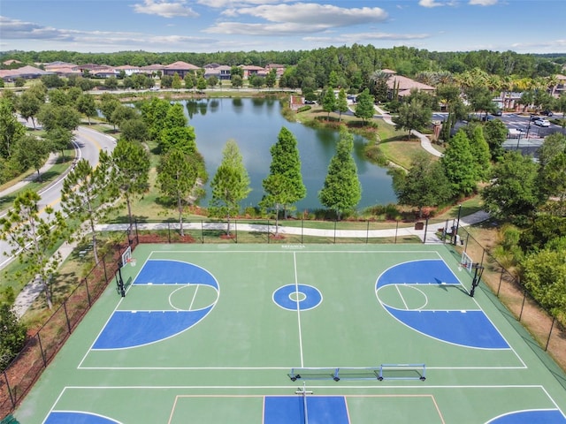 view of sport court with community basketball court, a water view, and fence