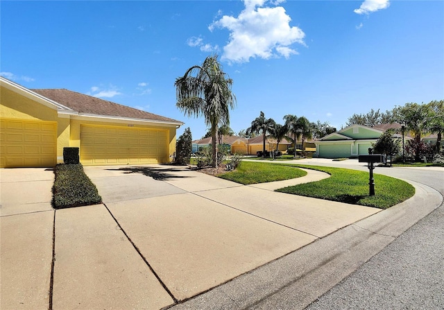 view of side of property featuring stucco siding, concrete driveway, and a garage