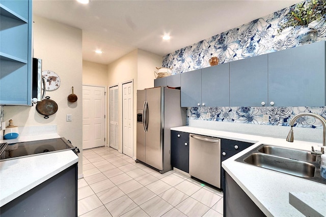 kitchen featuring open shelves, recessed lighting, a sink, light countertops, and appliances with stainless steel finishes