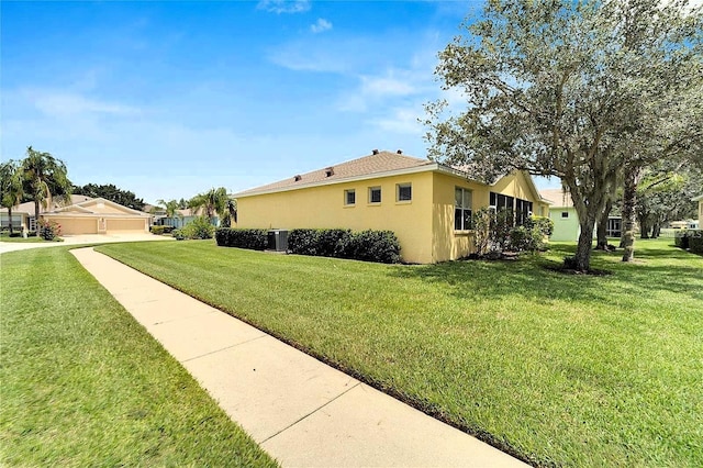 view of property exterior featuring stucco siding, a lawn, and cooling unit