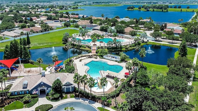 drone / aerial view with a residential view and a water view