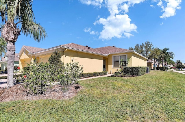 11539 Captiva Kay Dr, Riverview, FL 33569 - view of front of property with a garage, a front yard, and stucco siding