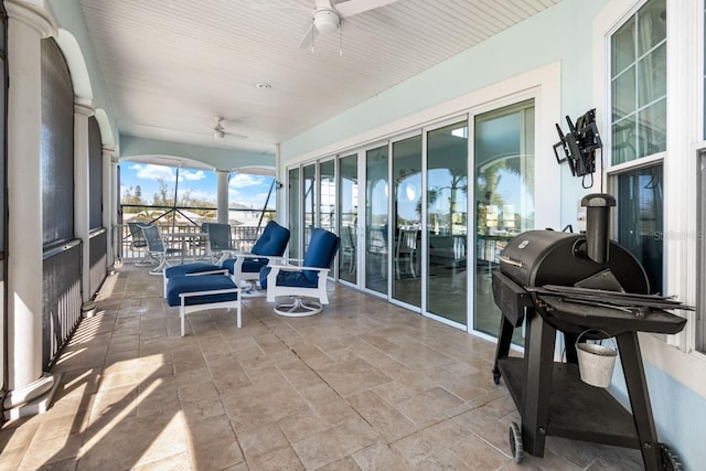 sunroom featuring a ceiling fan