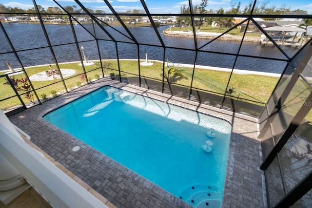 view of pool with a yard, a water view, a lanai, and a patio area