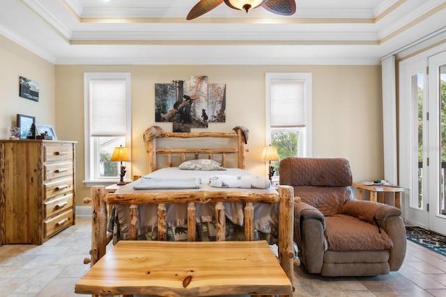 bedroom featuring multiple windows, crown molding, and a raised ceiling