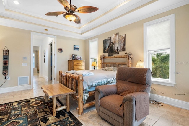 bedroom with visible vents, crown molding, a raised ceiling, and baseboards