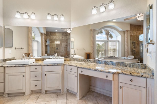 full bath featuring a stall shower, ceiling fan, and a sink