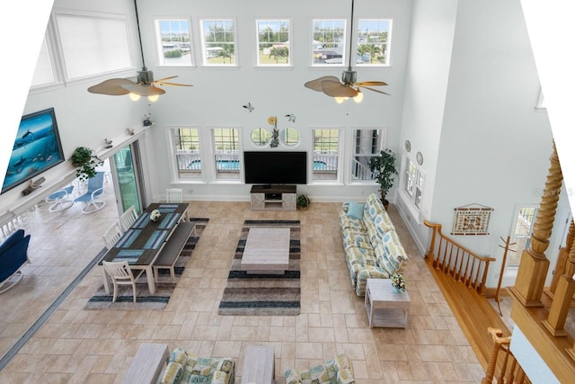 living room featuring a high ceiling and a ceiling fan