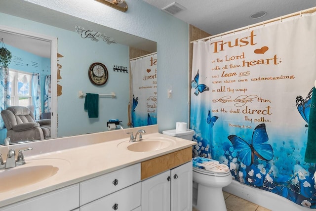 full bath with tile patterned floors, visible vents, double vanity, and a sink