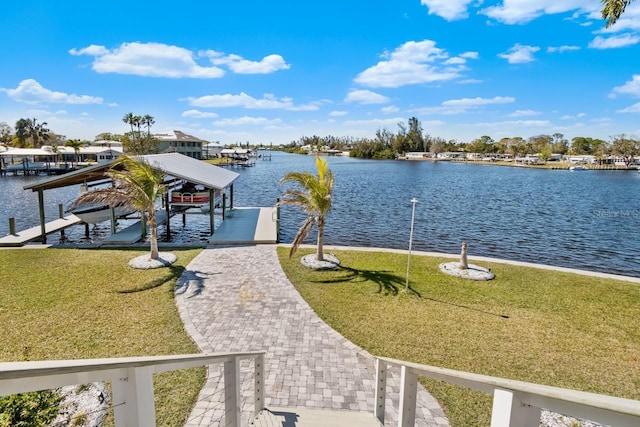 exterior space with boat lift, a water view, and a lawn