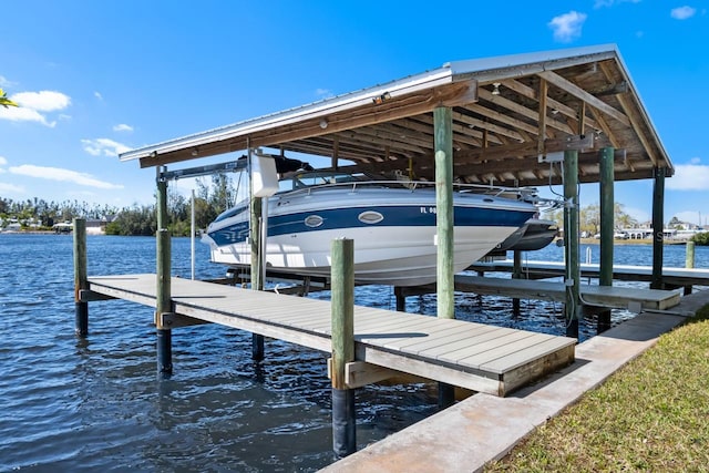 view of dock with boat lift and a water view