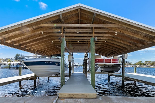 view of dock featuring boat lift and a water view